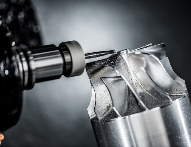 Metalworking CNC milling machine. Cutting metal modern processing technology. Small depth of field. Warning - authentic shooting in challenging conditions. A little bit grain and maybe blurred.