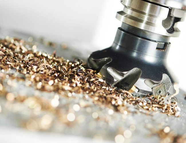 industrial metalworking machining cutting process of blank detail by milling cutter with hardmetal carbide insert at modern cnc machine.